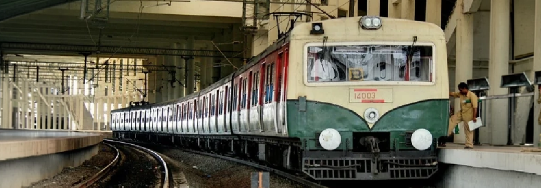 Indian Railways passenger train standing at a railway station platform, representing railway infrastructure and station modernisation.