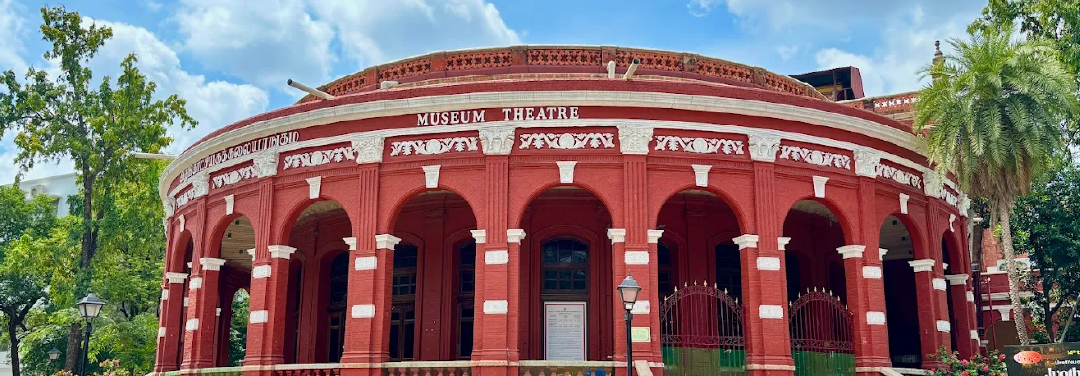 Historic red Indo-Saracenic architecture of the Government Museum complex in Egmore, Chennai, featuring arched entrances and ornate details.