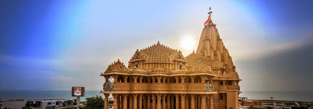 Ornately carved Dwarkadhish Temple in Dwarka, Gujarat, featuring traditional Hindu temple architecture, intricate stone pillars and a towering shikhara.