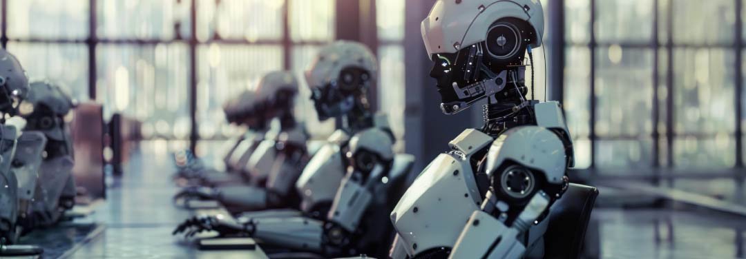 Row of futuristic humanoid robots working at computer stations inside a modern technology facility.