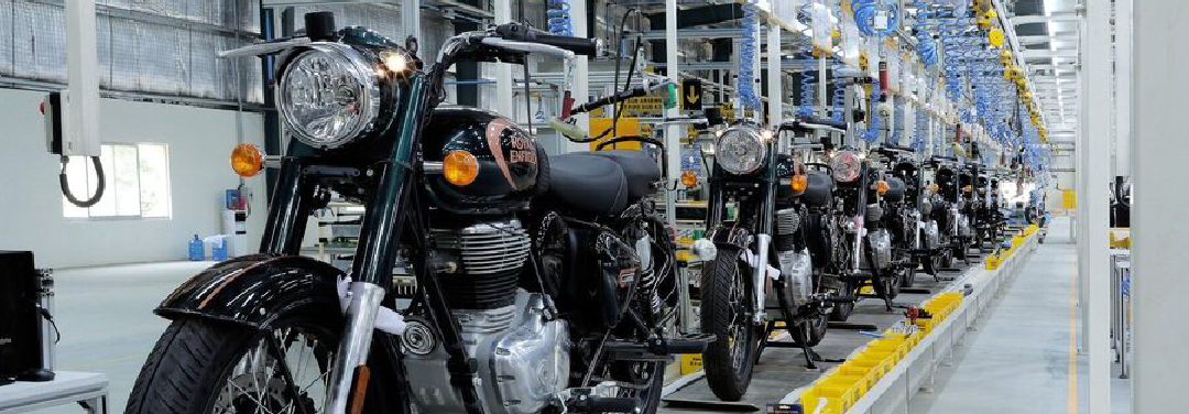 Royal Enfield motorcycles lined up on a factory assembly line, showcasing motorcycle manufacturing and production processes.