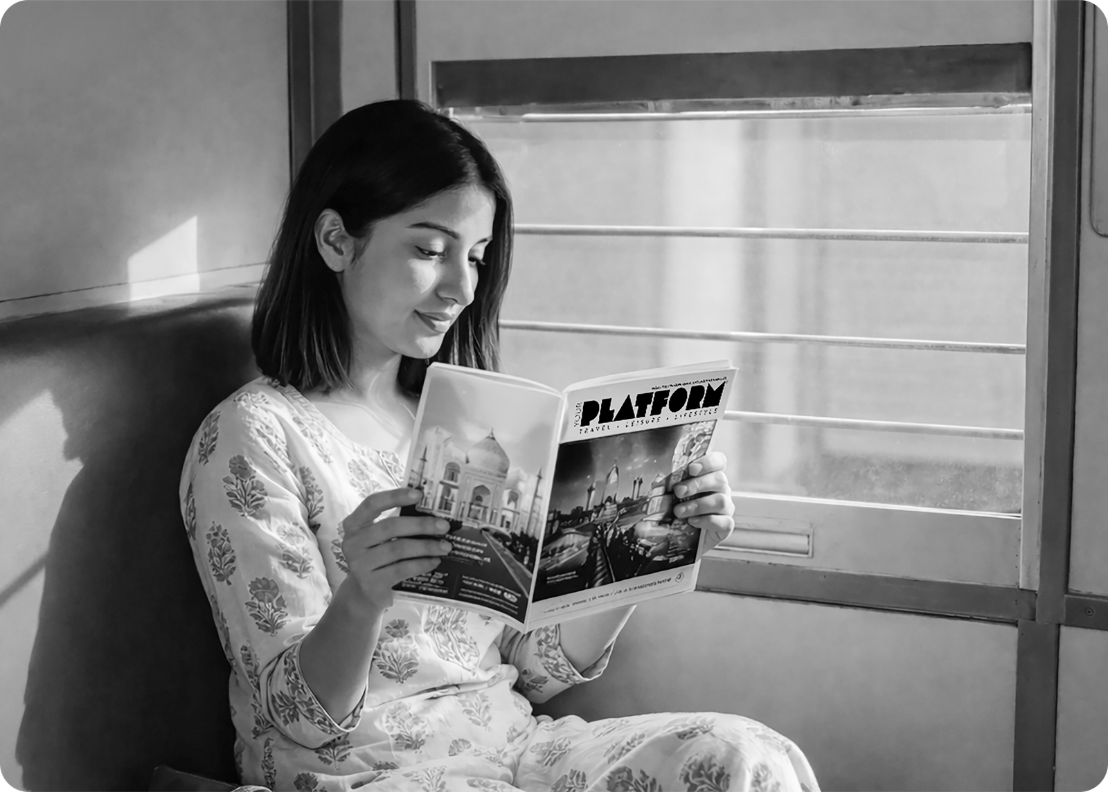 Woman reading Platform magazine on a train
