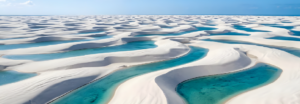 Aerial view of turquoise-blue water channels winding through white sand, creating striking natural patterns.